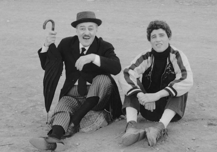 A man and a young man sitting on the floor